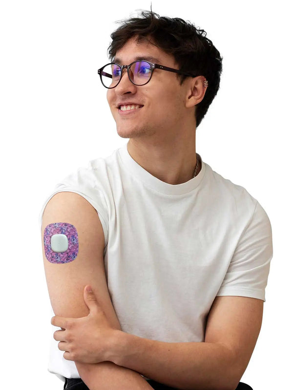 Man wearing Simplera Sensor Patch on arm, colorful design, for Medtronic Simplera CGM, comfortable and secure fit.
