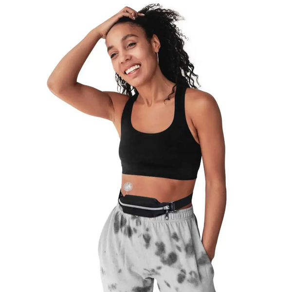 Wide insulin pump belly pouch worn by a person, demonstrating versatile placement for comfort and security.