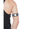 A person wearing a Freestyle Libre 2 Armband with a patterned strap on their upper arm. The armband securely holds the sensor.