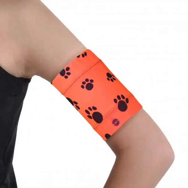 Fluorescent protective armband for insulin patch pump and glucose sensor with paw print design.