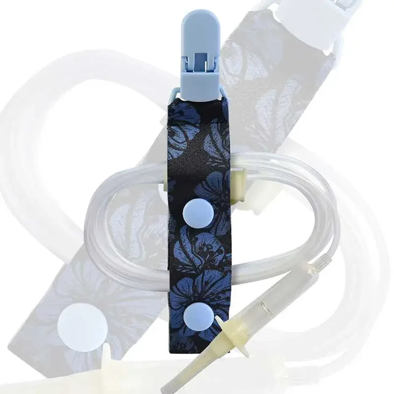 Kaio-Tube Clip with blue floral fabric and light blue buttons, securing medical tubing for organized and comfortable wear. Obraz