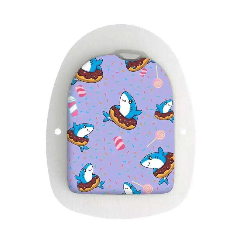 A colorful Omnipod POD sticker featuring cute blue sharks floating in donuts on a purple background adorned with candy and sprinkles. Obraz