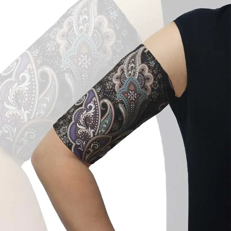 PICC line arm sleeve with a black background and colorful paisley pattern, worn on an arm for comfortable, protective daily use. Obraz