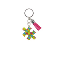 Medical Awareness Keychain featuring a colorful puzzle piece for Autism Awareness with a pink tassel.