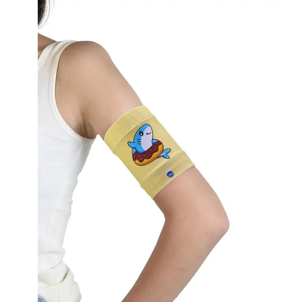 Colorful children's armband with shark design, ideal for securing glucose sensors and insulin pumps.