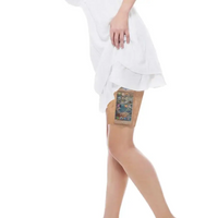 Lace garter leg band securing an insulin pump under a white dress