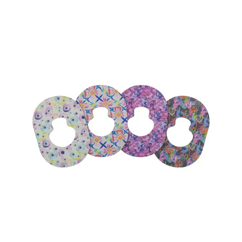 Four Guardian Enlite adhesive patches with vibrant patterns for a secure hold