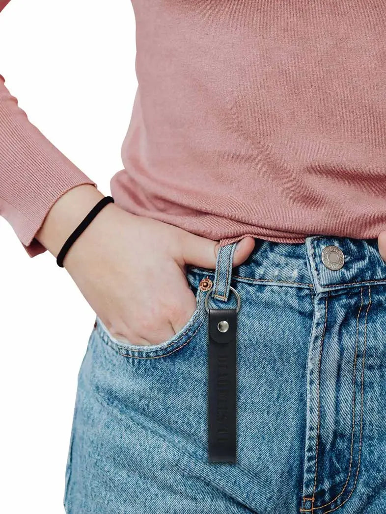 Diabetes T1 leather keychain attached to denim jeans, promoting diabetes awareness.