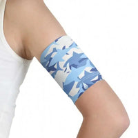 Glucose sensor armband for kids with blue sea-themed pattern, stretchy and secure fit.