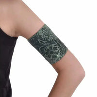 Stylish blood glucose sensor armband in dark printed colors for diabetes management.